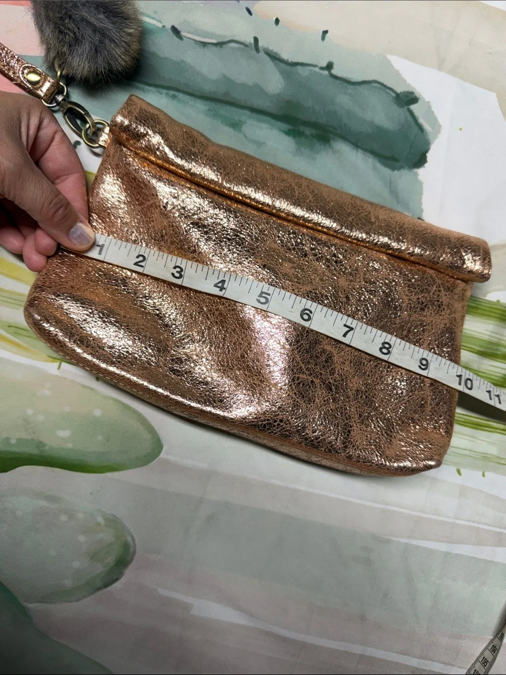 Miss Albright Metallic Rose Gold Wristlet Clutch with Pom Pom Accent